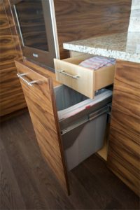This fun custom cabinet feature hides both the garbage and a drawer to hold extra trash bags, dish towels, or whatever.