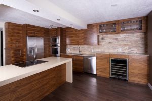After photo of the horizontal walnut cabinets that run throughout this truly contemporary kitchen. This kitchen looks so good now, we think it should be on the cover of a magazine!