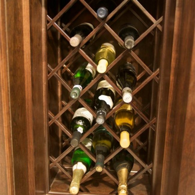 A close-up view of an under-counter built in lattice wine storage rack that's both functional and fun to look at.