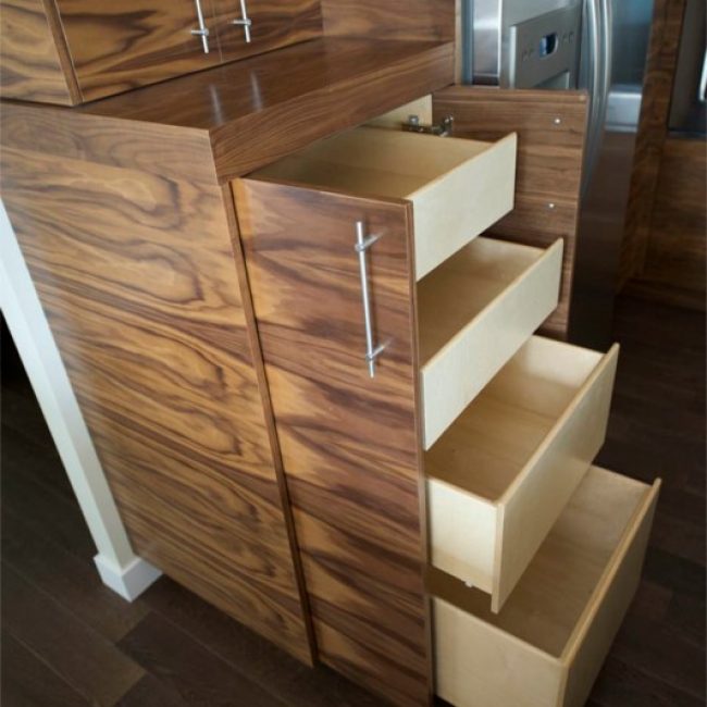 A close-up sideview of how our custom pull-out pantry drawers look and work, shown here in our horizontal walnut kitchen cabinets project.